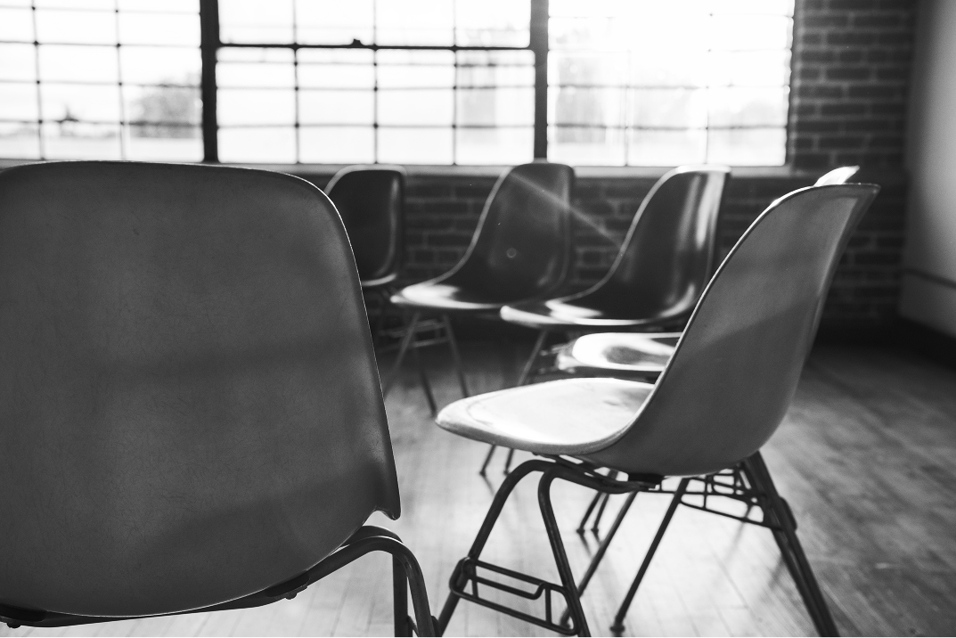 Empty chairs in a room with natural light